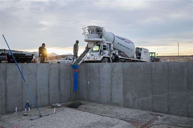 Concrete truck pouring slab for commercial construction project